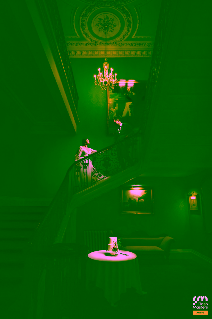 Bride and groom photographed on the grand staircase at Addington Palace