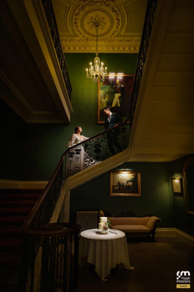 An award winning photo of the bride and groom on the staircase at Addington Palace